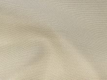 Nahaufnahme von einem Outdoorstoff mit gewebtem Muster in beige